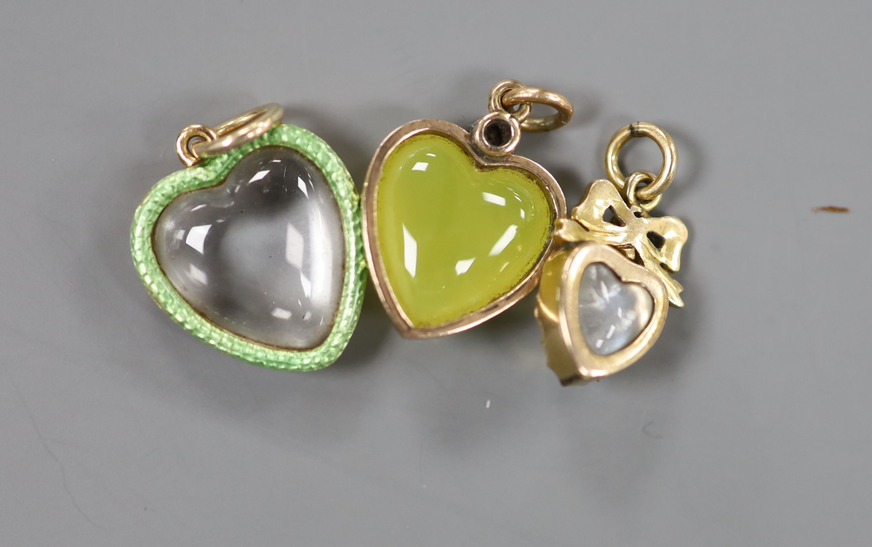 A yellow metal green chalcedony? and diamond set heart bar brooch, 34mm and three other heart shaped pendants including enamel and gem set, gross 11.4 grams.